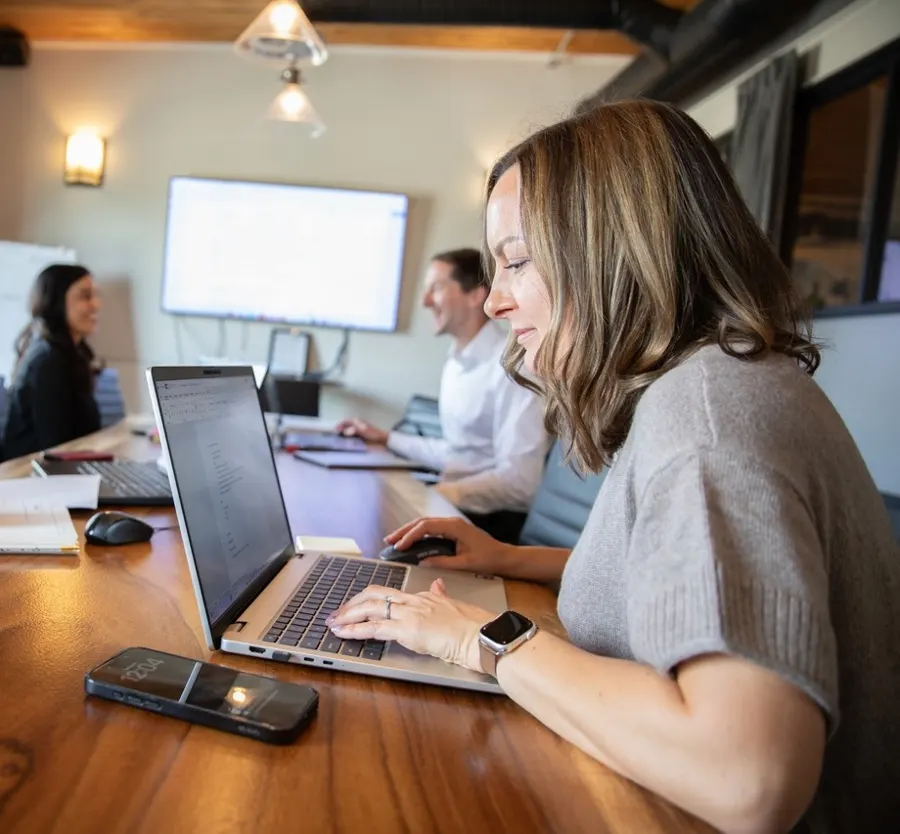 Acquen partners working together at the boardroom table